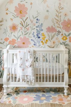 a white crib in front of a floral wallpaper and rug with flowers on it