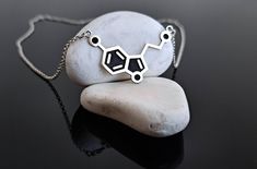 ◼️ Serotonin Molecule Handmade 925 Sterling Silver Necklace Sterling silver serotonin molecule necklace symbolizing happiness and well-being. A perfect gift for science lovers and wellness enthusiasts, this minimalist design is ideal for daily wear. * All jewelry is handcrafted with care in my workshop and is individually produced. * All of my products are Anti Allergic. You should definitely see the other designs in my workshop👇 https://www.etsy.com/shop/AnemonJewelryDesigns Material💎 Pendants and Chains are High Quality Solid 925 Sterling Silver. Pendant Height: 23 mm - 0.9" inches Pendant Width: 38 mm - 1.5" inches Pendant Thickness: 0.8mm Packaging🎁 All jewelry comes packaged in stylish boxes. Changes and Cancellations🔁 If you wish to make additional changes to your order, please c Serotonin Molecule, Chemistry Gifts, Molecule Necklace, Science Lover, Solid 925 Sterling Silver, Sterling Silver Necklaces, Minimalist Design, Jewelry Necklace Pendant, Daily Wear