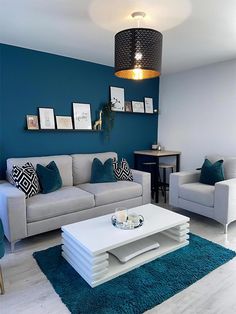 a living room with blue walls and white furniture