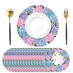 a plate, fork and knife are sitting on a place mat with flowers in the center