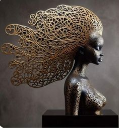 an intricately designed sculpture is displayed on a black pedestal with a gray wall in the background