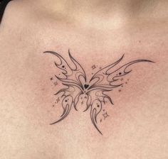 a woman's chest with a butterfly tattoo design on her left side ribcage