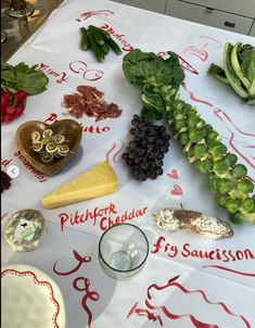 a table topped with lots of different types of vegetables and cheese on top of it