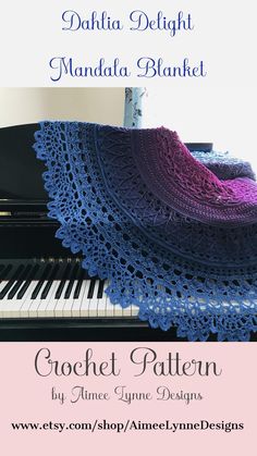 a crocheted blanket sitting on top of a black piano with the words dahla delight