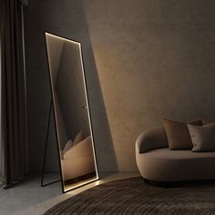 a large mirror sitting on top of a floor next to a couch