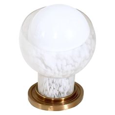 a white marble ball on a brass base