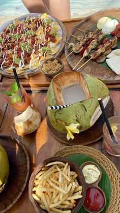 a table topped with different types of food and drinks on top of plates next to each other