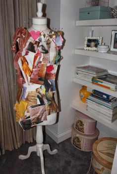 a mannequin is covered with many pieces of paper