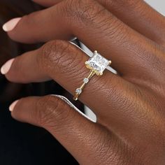 a woman's hand with a diamond ring on her finger and an engagement band