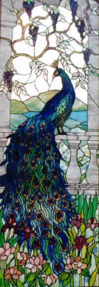 a stained glass window with a peacock on it's back and flowers in the background