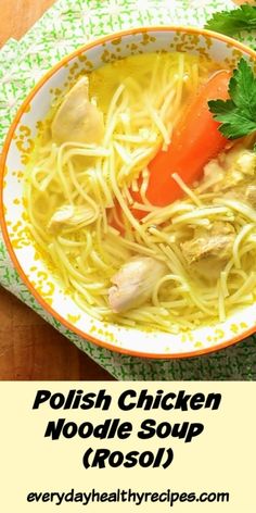 a bowl of chicken noodle soup with carrots and parsley on the side