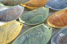 many different colored bowls with designs on them