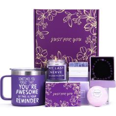 the purple gift box contains two mugs, a candle, and some other items