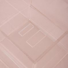 a white toilet sitting next to a pink tiled wall