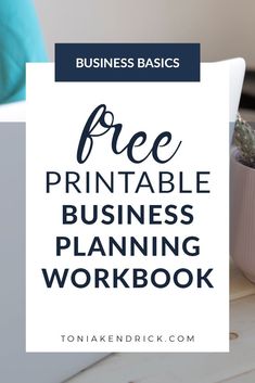 a laptop computer sitting on top of a desk next to a potted plant with the words free printable business planning workbook