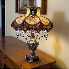 an ornate lamp is sitting on a table