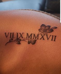 a close up of a tattoo on the back of a woman's shoulder that says vil xx mmxvi