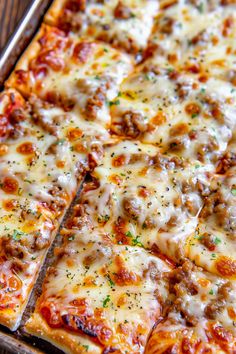 a close up of a pizza with cheese and meat toppings on it's crust