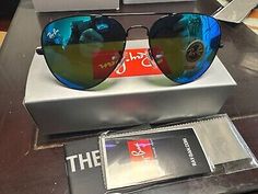 a pair of sunglasses sitting on top of a table next to a box with the price tag