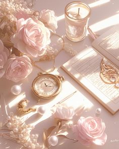 a table topped with lots of pink flowers next to an open book and a candle