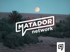 the logo for matador network in front of a desert landscape