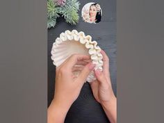 a person holding a paper plate next to some succulents