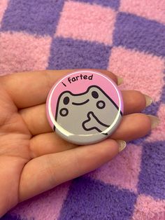 a hand holding a button with a cartoon character on it that says, i forgot