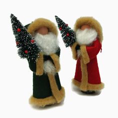 two small christmas gnomes are standing next to each other