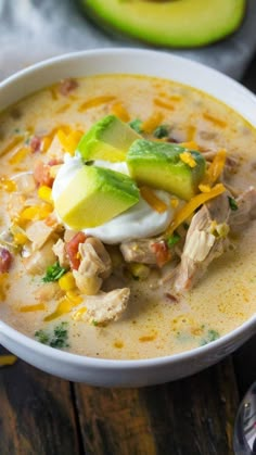 a white bowl filled with chicken and avocado soup