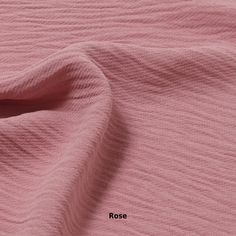 close up view of pink fabric with the word rose on it