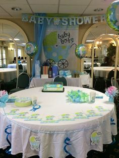 a baby shower themed party with balloons and decorations on the table for an infant's first birthday