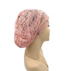 a mannequin head wearing a pink turban with sequins on it