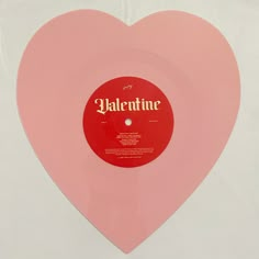 a pink heart shaped vinyl record with the word valentine on it