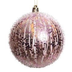 a pink ornament hanging from a gold chain