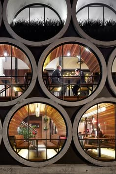 several circular windows are shown in the middle of a room with grass growing on it