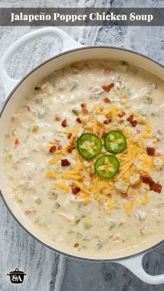 jalapeno popper chicken soup in a white bowl with cheese and green peppers