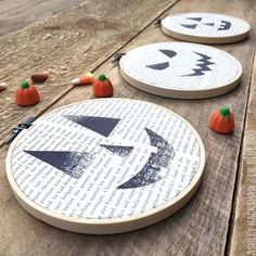 three pumpkins and two jack - o'- lantern cross stitched on wooden boards