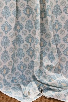 a blue and white curtain with an intricate pattern