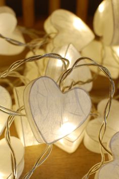 white heart shaped string lights on a wooden table