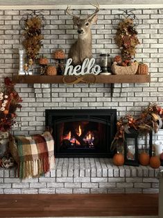 the fireplace is decorated with fall decorations and deer heads