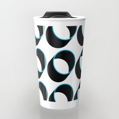 a black and white coffee cup with blue circles on it