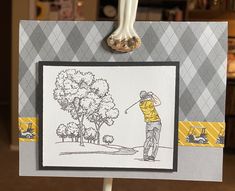 a card with a drawing of a man playing golf on the tee and holding a golf club