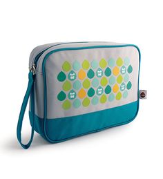 a blue and white bag with green dots on it's side, in front of a white background