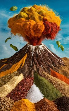 an image of a volcano made out of different colored powders and spices in the air