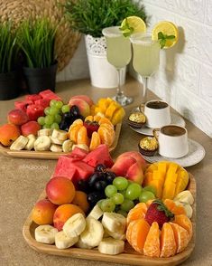 two trays filled with fruit on top of a table