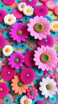 many different colored flowers on a colorful surface