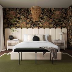 a bedroom with floral wallpaper and white bedding, green carpeted flooring