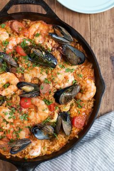 a skillet filled with seafood and rice