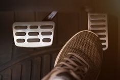 a person's feet in the back seat of a car, with their shoes off