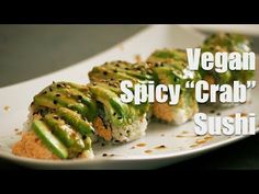 there is a plate with sushi on it and the words vegan spicy crab sushi